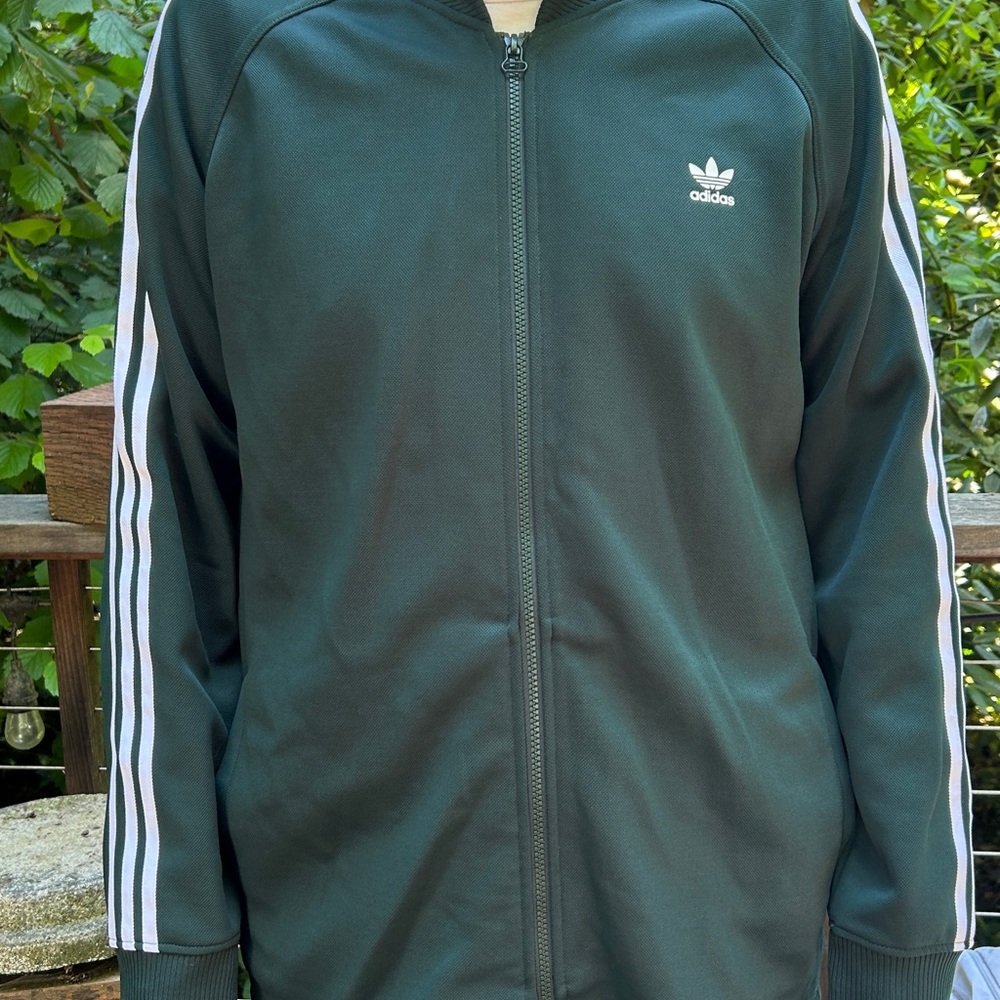 Adidas Men 3 stripes tricot jacket. Dark green w/ pocket in the back. Brand new.
